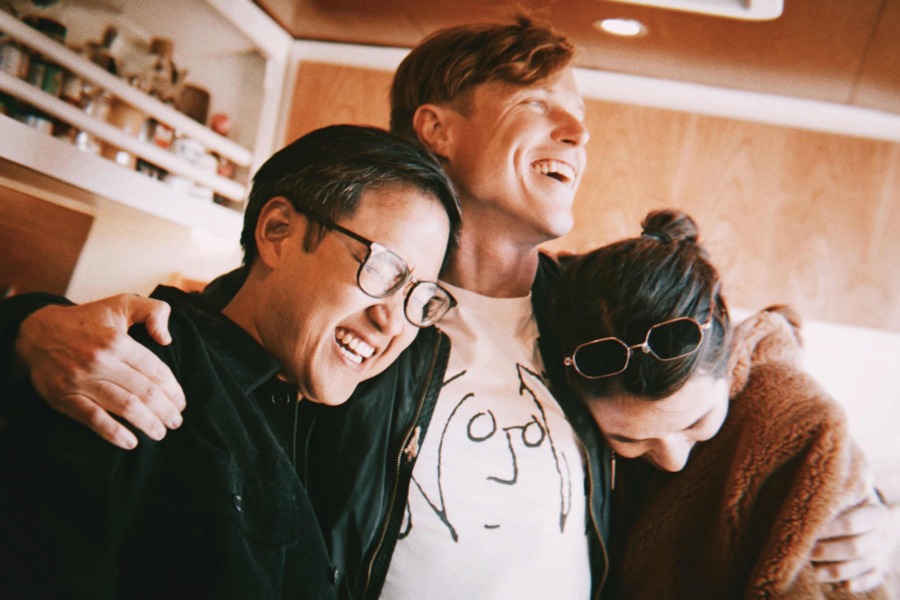 Ben, Jon and Clara of Streetlight Cadence hug and laugh in an episode of their Emmy-nominated television show, "Will Play For Food".